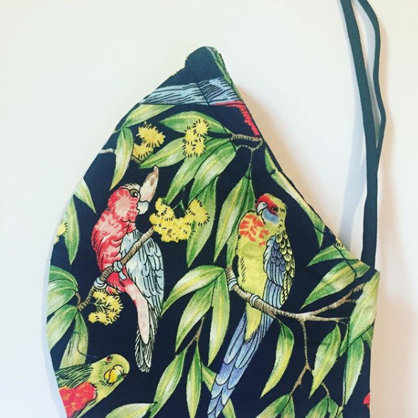 Triple layered face mask made in Melbourne Australia from cotton and poplin featuring a unique rainbow lorikeet bird parrot print