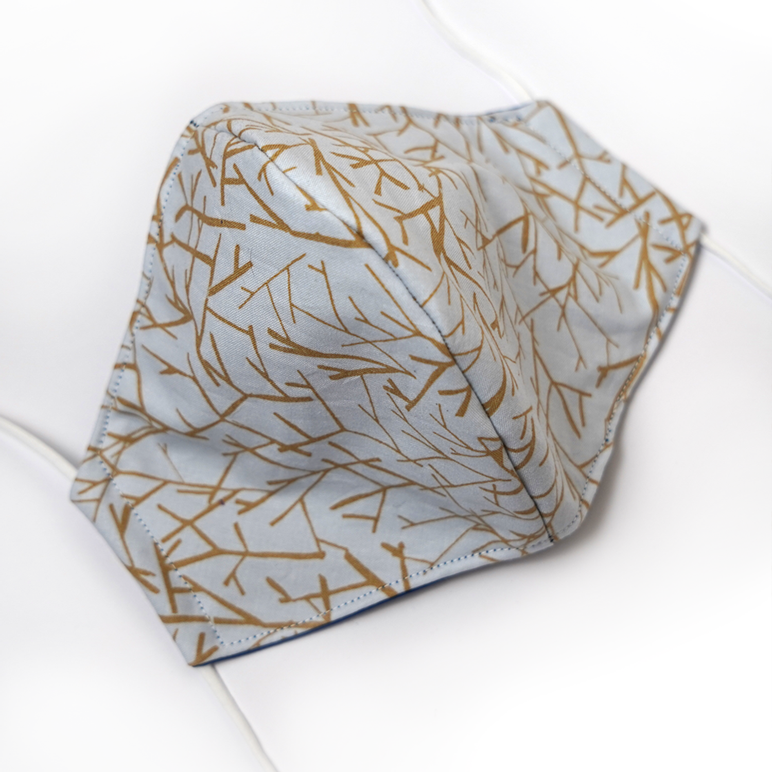 Triple layered face mask made in Melbourne Australia from cotton and poplin featuring a unique golden branch print